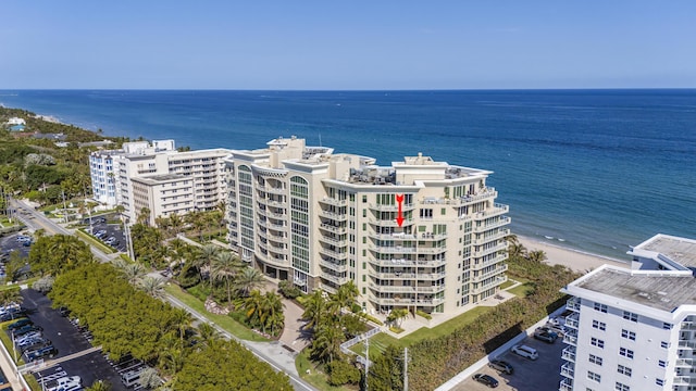 drone / aerial view featuring a water view and a view of the beach