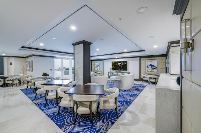 dining space featuring ornate columns, crown molding, and a tray ceiling