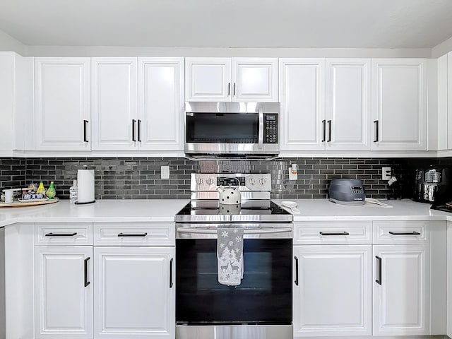 kitchen with white cabinetry, appliances with stainless steel finishes, and backsplash