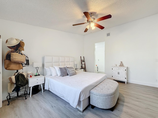 bedroom featuring wood-type flooring and a textured ceiling