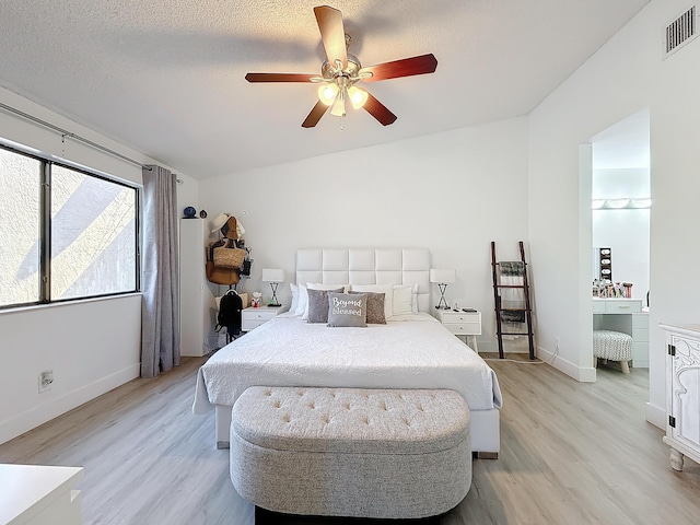 bedroom with ceiling fan, a textured ceiling, and light wood-type flooring