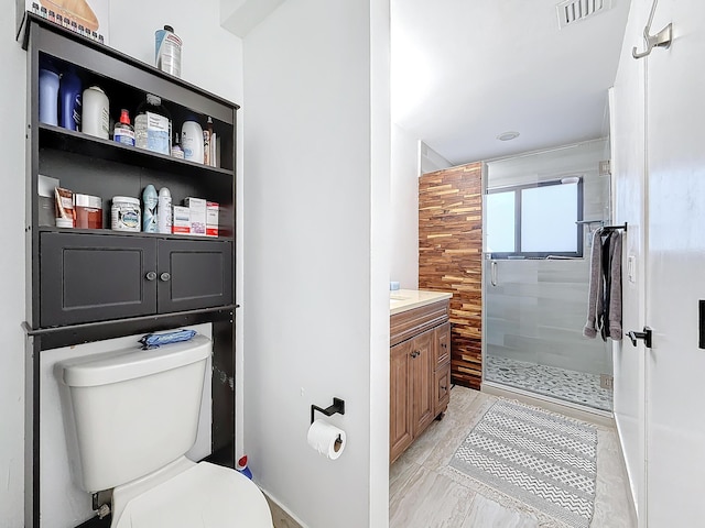 bathroom with vanity, an enclosed shower, and toilet