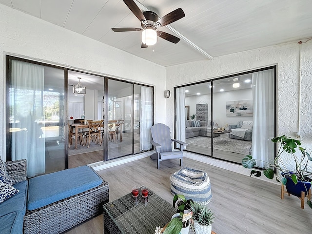 living room featuring ceiling fan and wood-type flooring