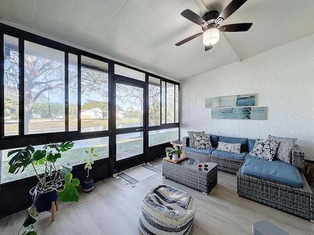 sunroom / solarium featuring ceiling fan, a healthy amount of sunlight, and vaulted ceiling