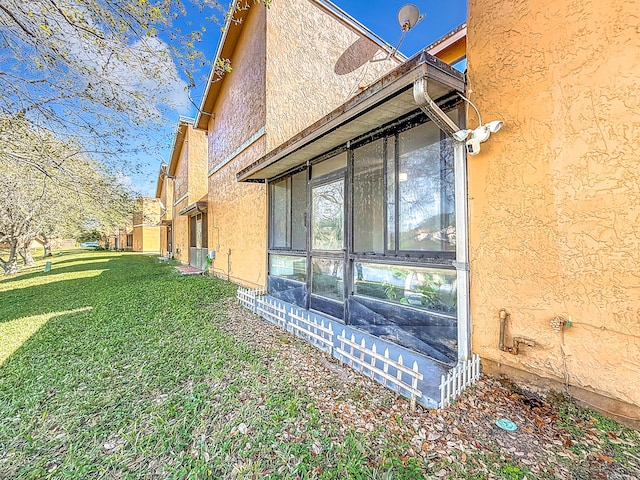 view of home's exterior with a yard