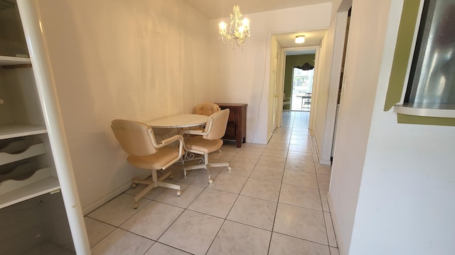 dining area featuring light tile patterned floors and a chandelier