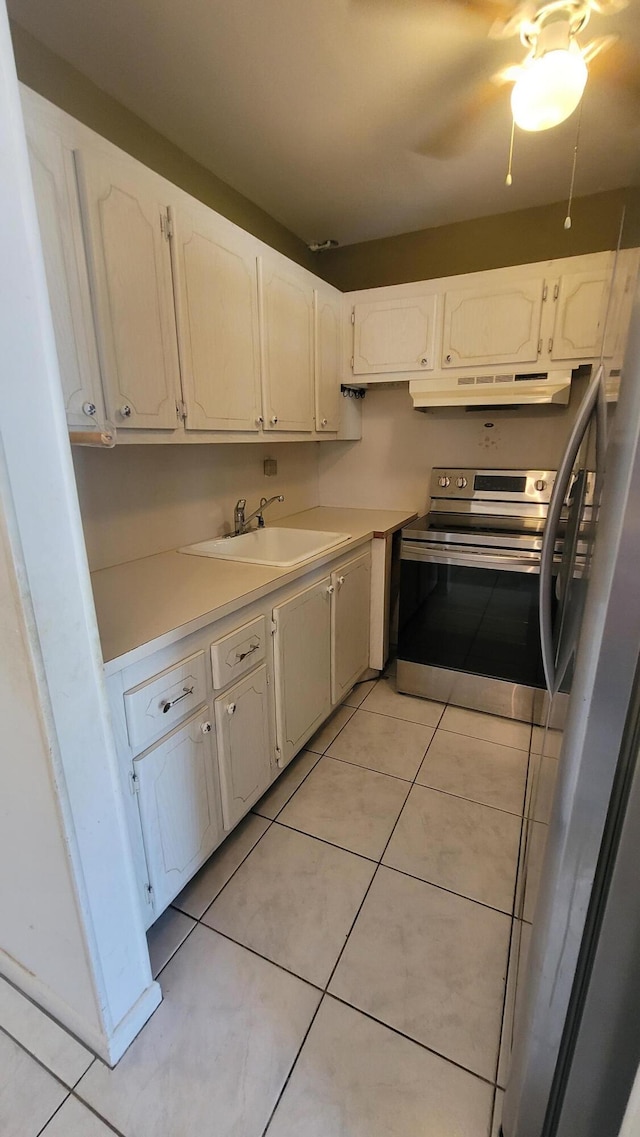 kitchen featuring white cabinetry, stainless steel electric range oven, sink, and light tile patterned floors