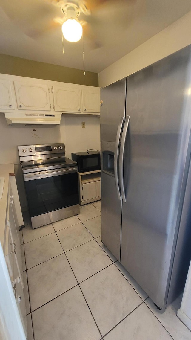 kitchen featuring white cabinetry, stainless steel appliances, and light tile patterned flooring