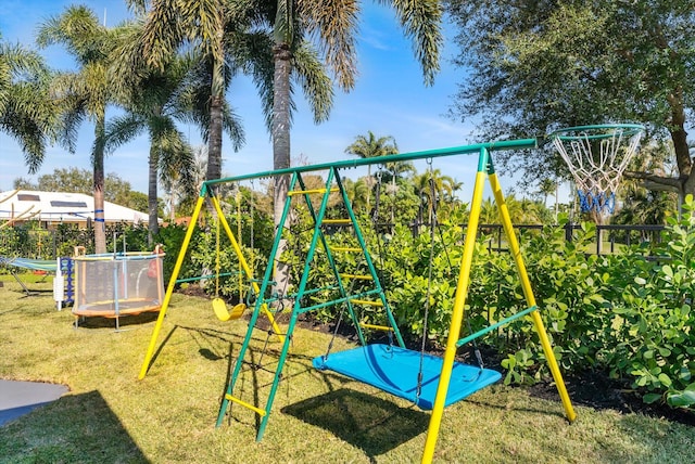 view of jungle gym with a trampoline and a lawn