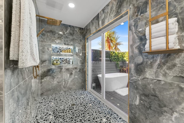 bathroom featuring independent shower and bath and tile walls