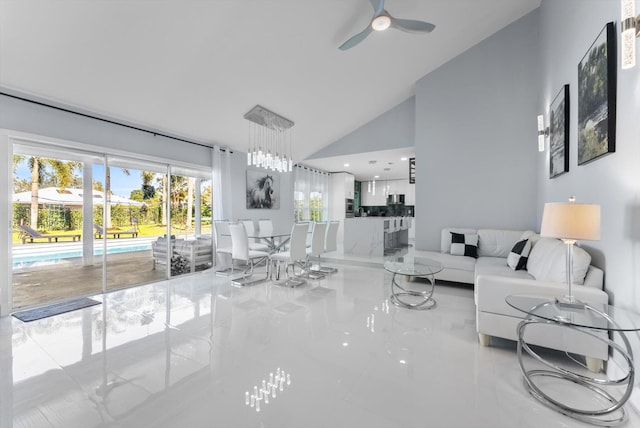 living room featuring ceiling fan and high vaulted ceiling