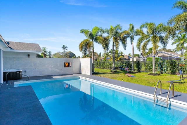 view of swimming pool featuring a yard and central AC