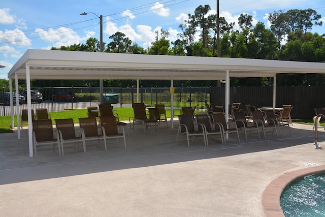 surrounding community with a pool and a patio area