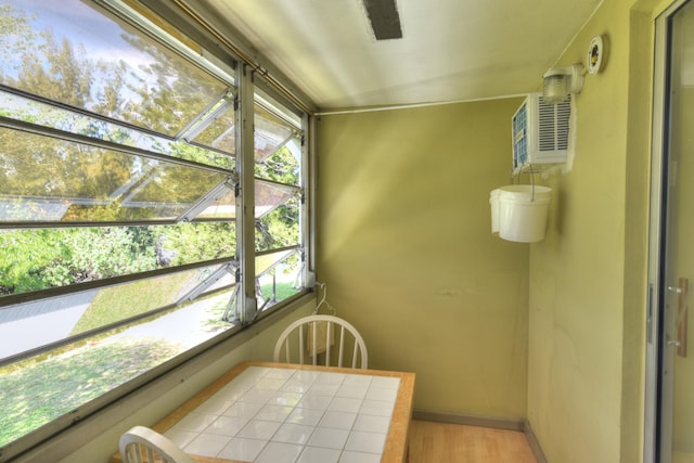 sunroom with a wall mounted air conditioner