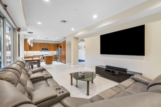 tiled living room featuring sink