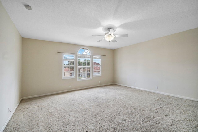 carpeted empty room featuring a textured ceiling and ceiling fan