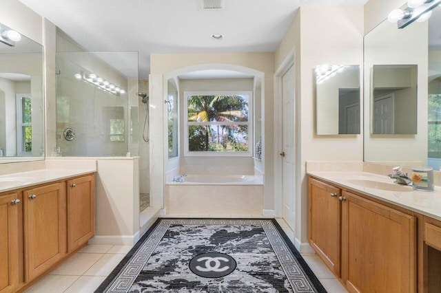 bathroom featuring tile patterned floors, separate shower and tub, and vanity