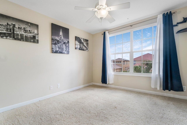 carpeted empty room featuring ceiling fan