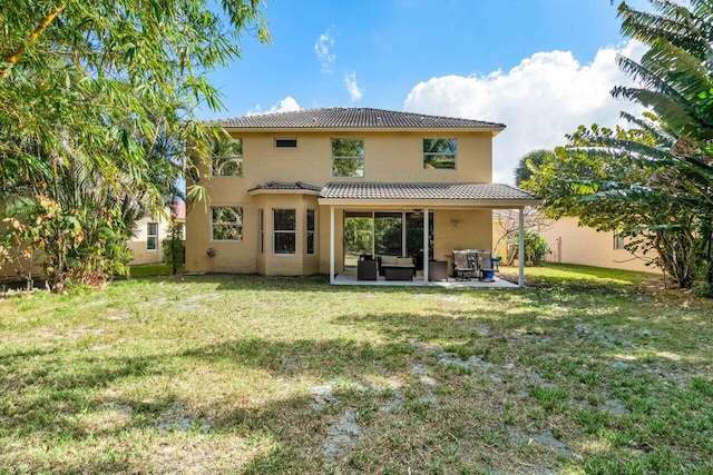 back of property featuring an outdoor living space, a patio area, and a lawn