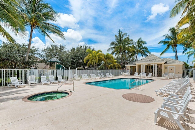 view of swimming pool featuring a patio area and a hot tub