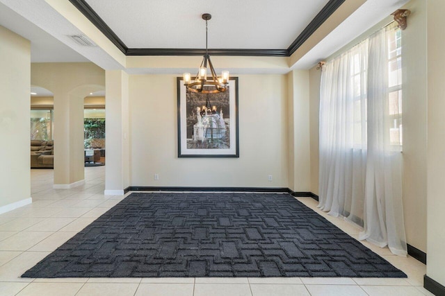 interior space with a raised ceiling, crown molding, and a notable chandelier