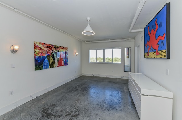 unfurnished room featuring concrete floors