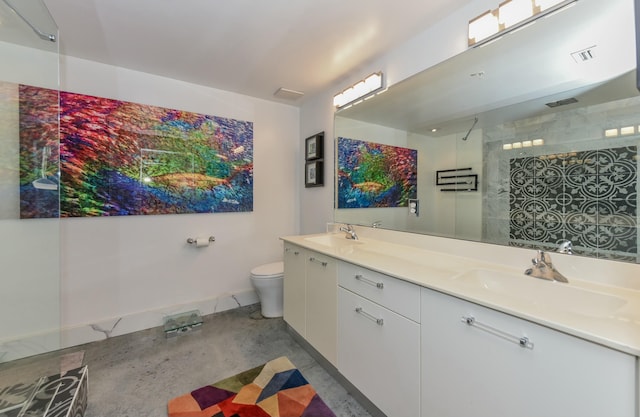 bathroom featuring vanity, toilet, and a shower