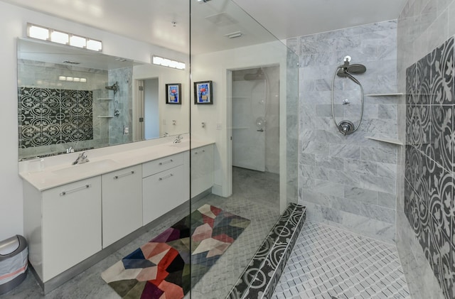 bathroom featuring vanity and tiled shower