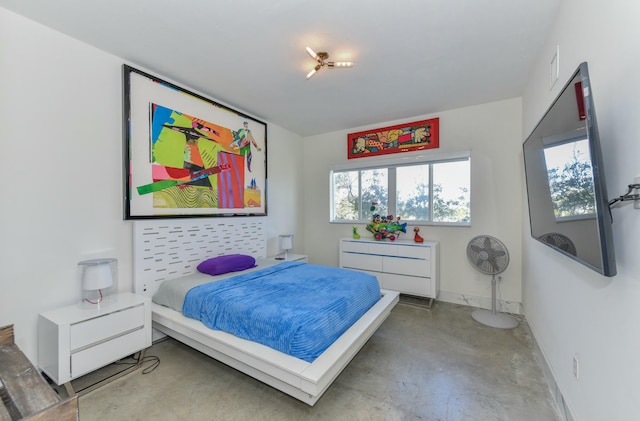 bedroom featuring concrete flooring