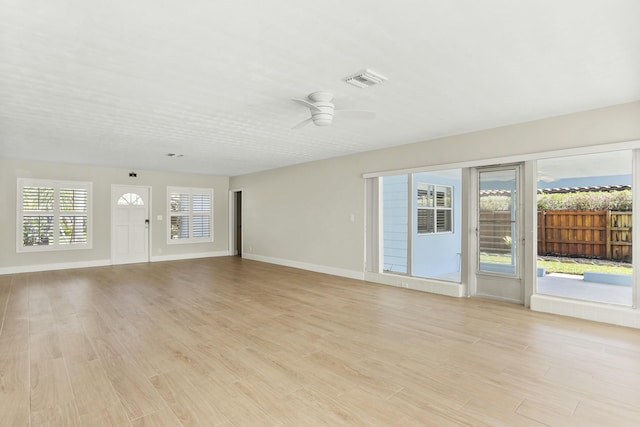 unfurnished living room with ceiling fan and light hardwood / wood-style floors