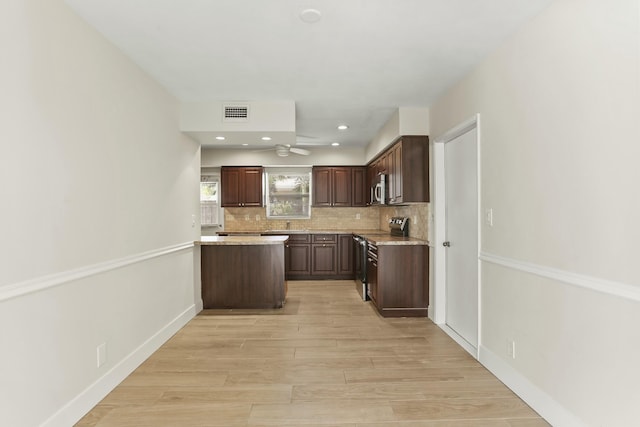 kitchen with appliances with stainless steel finishes, light hardwood / wood-style flooring, dark brown cabinetry, and decorative backsplash