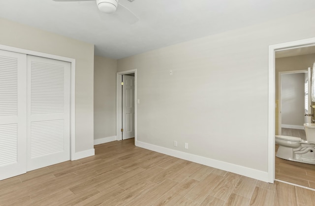 unfurnished bedroom with ceiling fan, ensuite bath, light hardwood / wood-style floors, and a closet