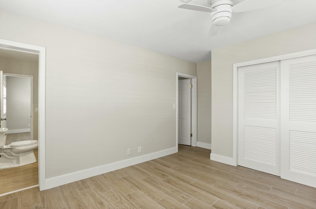 unfurnished bedroom with ceiling fan, connected bathroom, light wood-type flooring, and a closet