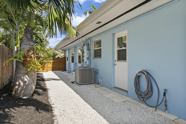 view of side of property featuring central AC and a patio area