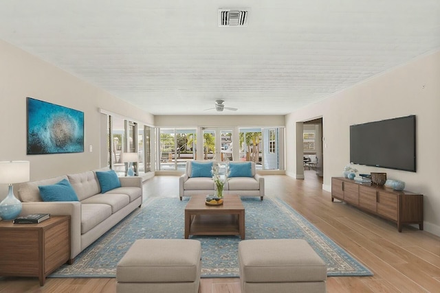 living room featuring light hardwood / wood-style flooring and ceiling fan