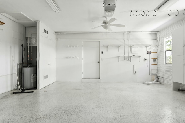 garage featuring ceiling fan and electric water heater