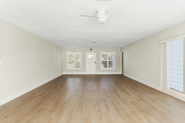 unfurnished living room featuring light hardwood / wood-style flooring and ceiling fan