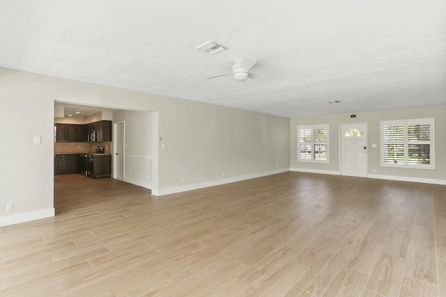 unfurnished living room with ceiling fan and light hardwood / wood-style floors