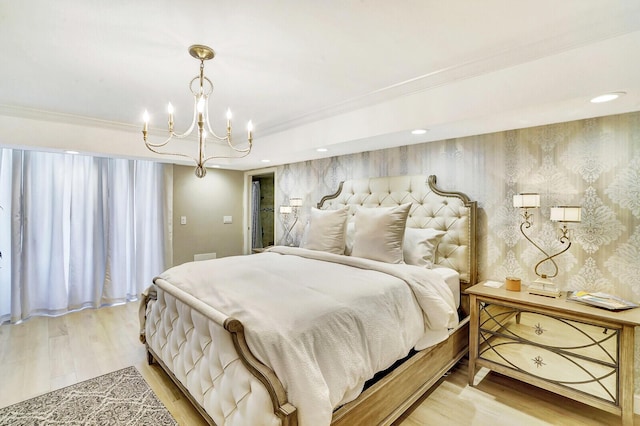 bedroom featuring an inviting chandelier, hardwood / wood-style floors, and crown molding