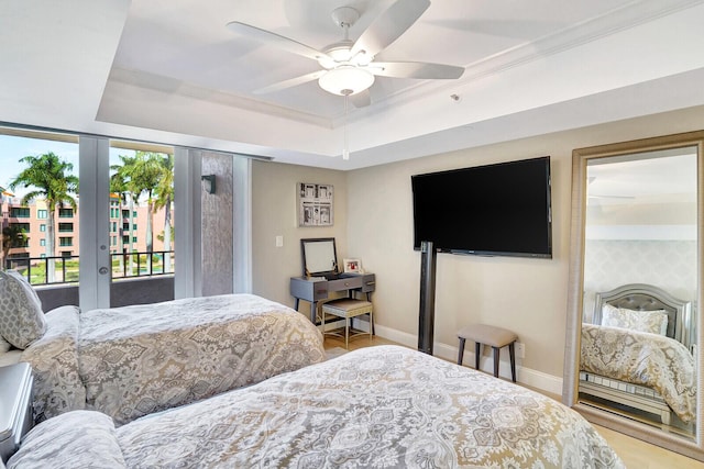 bedroom featuring ornamental molding, access to outside, ceiling fan, and a tray ceiling