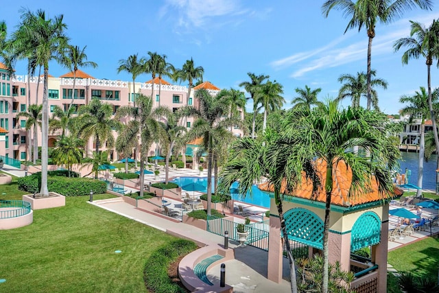 surrounding community featuring a water view, a yard, and a patio area