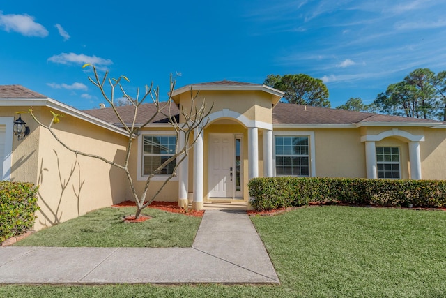 mediterranean / spanish-style home featuring a front lawn