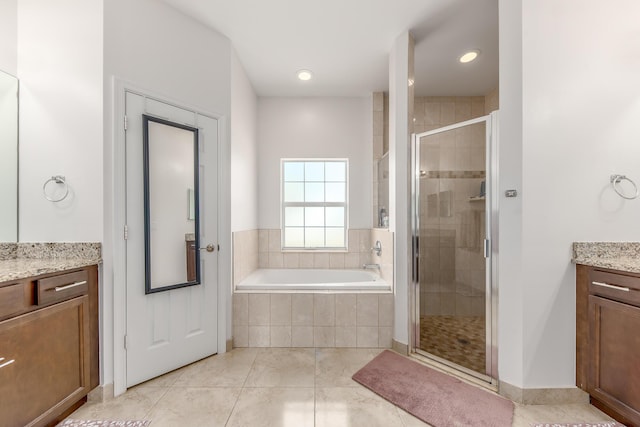 bathroom with vanity, tile patterned floors, and independent shower and bath