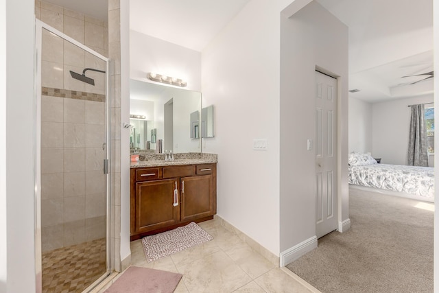 bathroom with vanity, a shower with shower door, and tile patterned floors