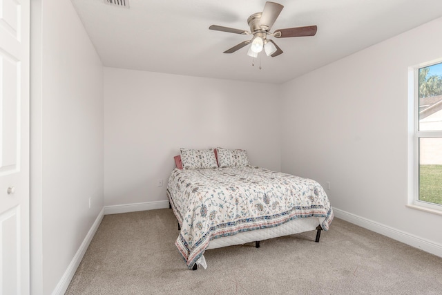 bedroom with light colored carpet and ceiling fan