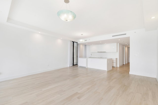 unfurnished living room with light hardwood / wood-style flooring