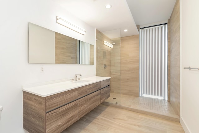 bathroom with vanity and a tile shower