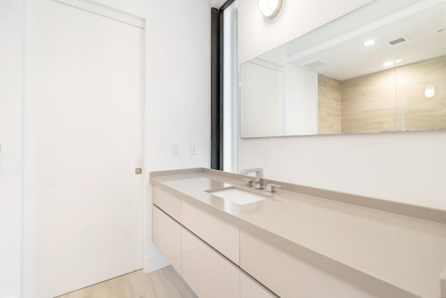 bathroom featuring vanity and hardwood / wood-style floors