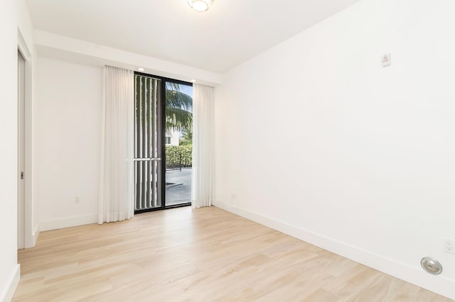 spare room with light wood-type flooring