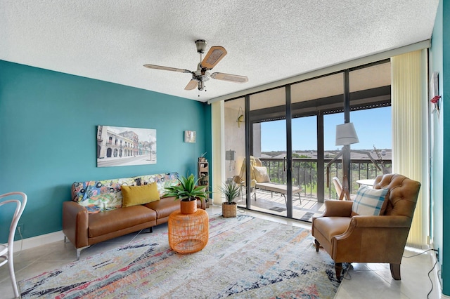 tiled living room with ceiling fan, a wall of windows, and a textured ceiling